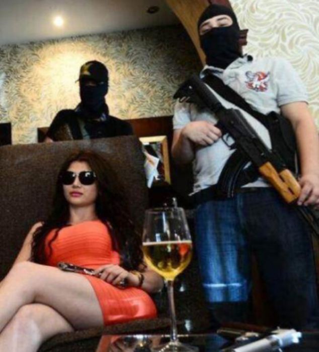 With Her Pink Ak-47 Assault Rifle They Call Her The Black Widow Maker After She Allegedly Took Over The Top Job At One Of Mexico's Deadliest Drug Mafia Gangs. And Although The Brunette Likes To Wear Designer Clothes And Post Pictures Of Herself On Twitter Mirroring Her Idol Kim Kardashian, Claudia Ochoa Felix Is According To Local Media Every Bit As Deadly As Her Black Widow Namesake. She Is Apparently Now The Leader Of The &Quot;Los Antrax&Quot; Hit Squad That Works For The Mexican Sinaloa Cartel Which Is One Of The Main Sources Of Heroin In America. The 27-Year-Old Makes No Secret Of Her Glamorous Lifestyle, With The Numerous Pictures She Posts On Social Media. With Low-Cut Dresses And Bright Red Lipstick And A Preference For Miniskirts The Only Thing Many Of The Shots Have Different To Any Other Young Woman Posting Selfies Are Her Snaps Of Favourite Things, Like Her Trademark Pink Ak-47 Assault Rifle, Or Her Pet Leopard. The Images Include Pictures Of Her Shopping In Luxury Boutiques, And Even Occasionally Include Shots Of Her Children Sometimes Lying With Hundreds Of Banknotes Surrounding Them In The Bath Or On The Bed. Claudia Married A Sinaloa Drug Trafficker Known As 'El Chavo' Felix With Whom She Had Three Children - However They Later Separated. &Quot;Los Antrax&Quot; Which She Is Rumoured To Lead Is The Drug Cartels Elite Contract Killer Squad, That Was Previously Led By Her Lover Jose Rodrigo Arechiga Gamboa, 33, Who Was Arrested In January. If There Is A Dirty Job That Needs To Be Sorted Out, Los Antrax Get The Assignment. They Also Provide The Guards That Carry Out The Security For The Cartel Boss Ismael &Quot;El Mayo&Quot; Zambada, 66. Initially She Was Not In The Public Spotlight, But All That Changed With The Murder Of A Young Woman, Yurina Castillo Torres, 23, On 7Th May, Who Local Media Say Was Killed By A Rival Gang After She Was Mistaken For Claudia. The Two Young Women Had Apparently Looked Similar. Since The Attack, Claudia Has Not Changed Her Lifestyle Much And Can Still Be Seen Clubbing In The Main Discos And Nightclubs Of Mazatlan, Culiacan And Guadalajara, But This Time Always Surrounded By Heavily Armed Men Who Protect Her. And Despite The Fact That A Rival Gang Seems Determined To Wipe Her Out In A Drugs War That Has Reportedly Cost Over 100,000 Lives Since 2006, She Denies Any Connection To Any Criminal Organisation, Saying Claims About Her Are Simply &Quot;Cowardly Lies And Slander&Quot;. (Ends)  