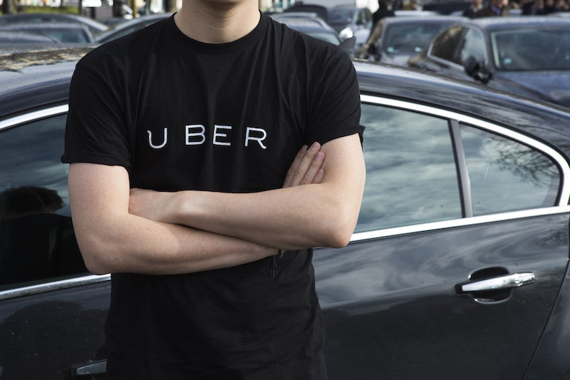 A Protester Wears A Shirt Displaying The Logo Of Smartphone Ride Service Uber