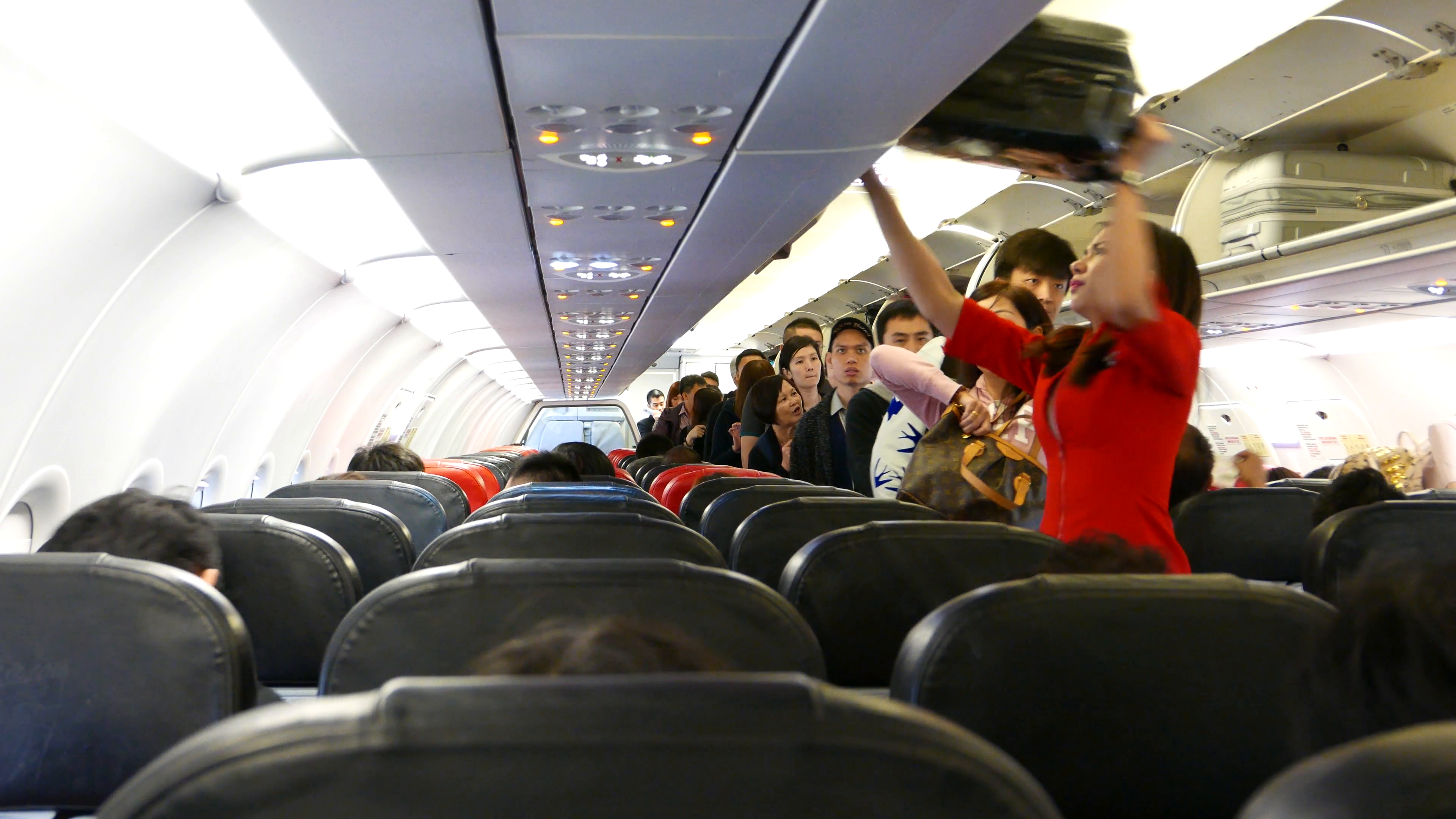 Inside Airasia Plane Boarding Time Stewardess Picks A Suitcase Luggage