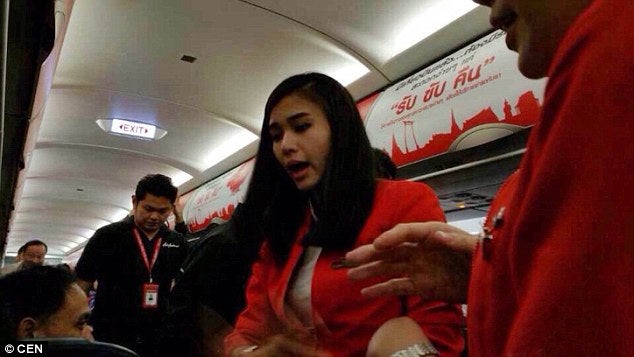 24112EA700000578 2873328 Thai AirAsia flight attendants plead for calm after one of their a 30 1418658320071