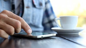 Man Using Mobile Smart Phone And Drink Coffee In Cafe Video