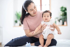 asian family motherhood concept happy smiling young asian mother with little baby home 35721 612