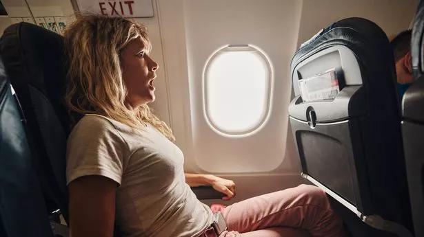 0 Fearful woman traveling by airplane.jpg