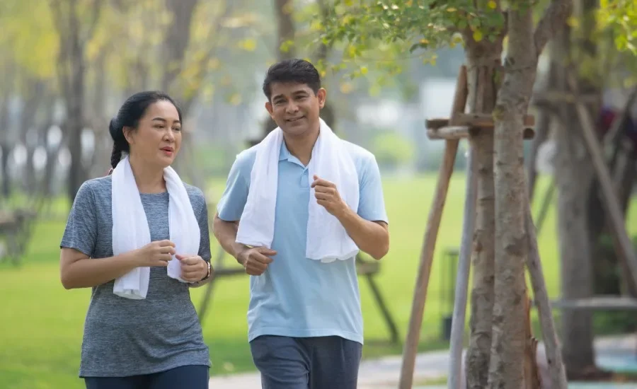 Male And Female Walk In A Park